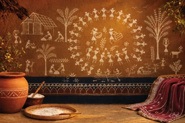 A respectful Warli-inspired cultural scene with white geometric figures, village life, circular dance, animals, and earthy wall-painting texture.